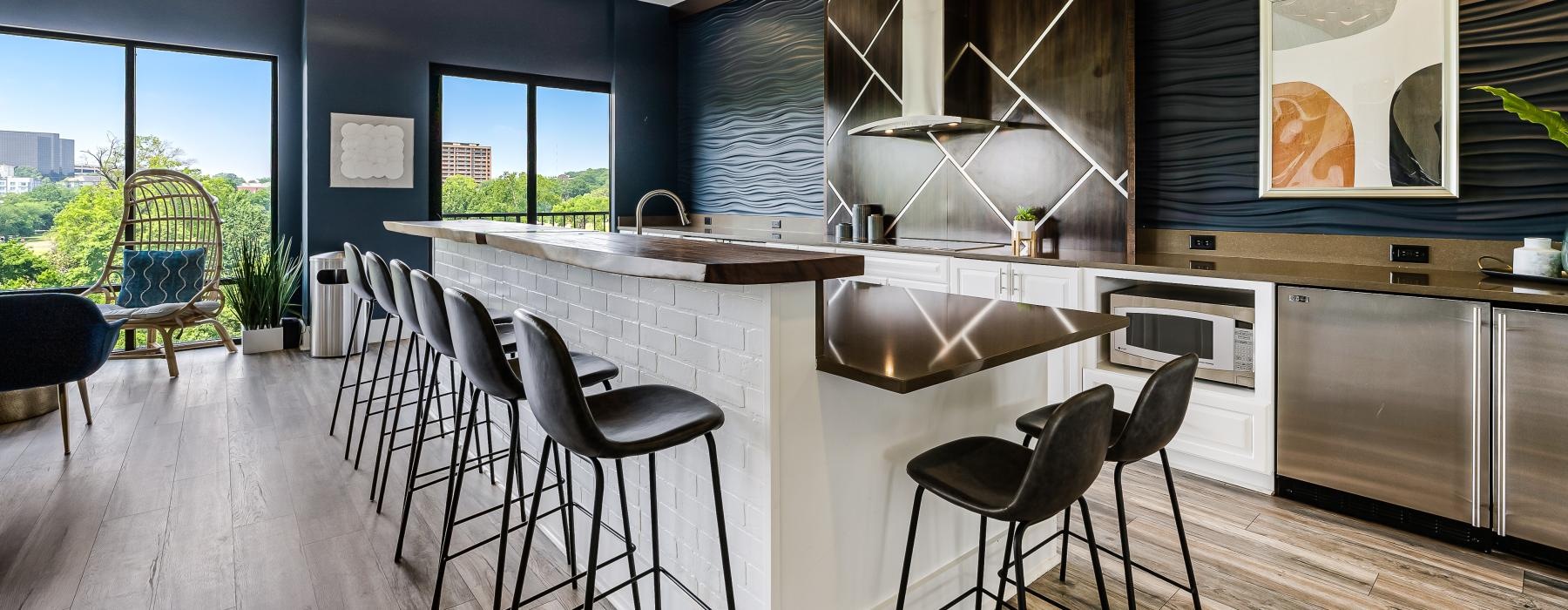 a kitchen with a large island in club room