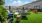 large lawn with chairs and tables near pool